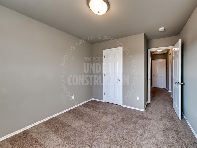 unfurnished bedroom with a closet and light carpet