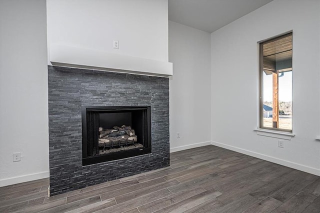 interior details with a fireplace and wood-type flooring