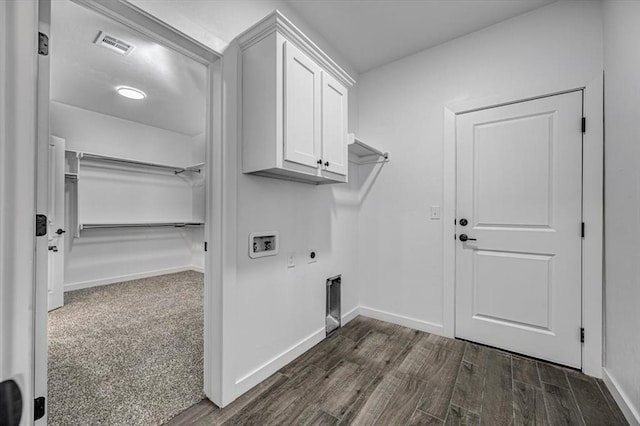 laundry room featuring hookup for a washing machine, electric dryer hookup, dark wood-type flooring, and cabinets