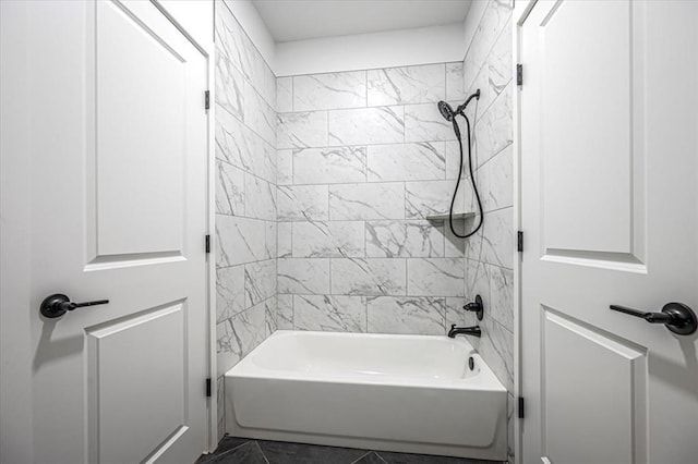 bathroom with tiled shower / bath combo and tile patterned flooring