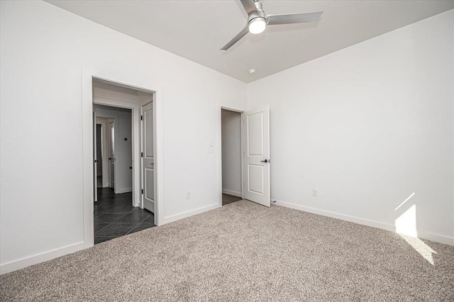 unfurnished bedroom featuring ceiling fan and dark colored carpet