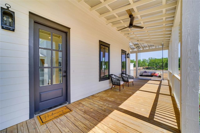 wooden deck with covered porch and ceiling fan