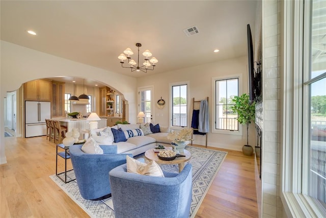 living room featuring light hardwood / wood-style flooring and a notable chandelier