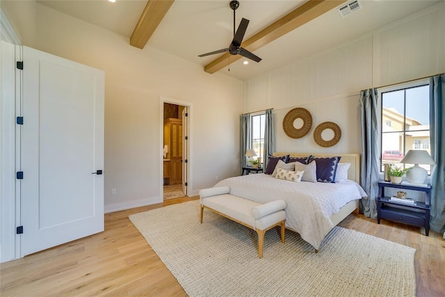 bedroom with ceiling fan, light hardwood / wood-style floors, multiple windows, and beam ceiling