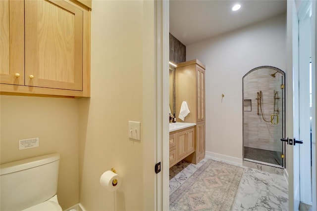 bathroom featuring vanity, toilet, and tiled shower