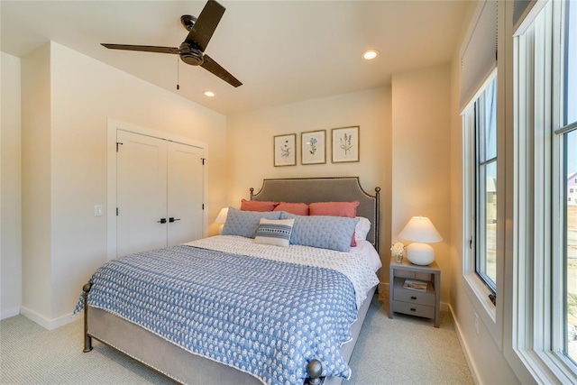 carpeted bedroom featuring a closet and ceiling fan