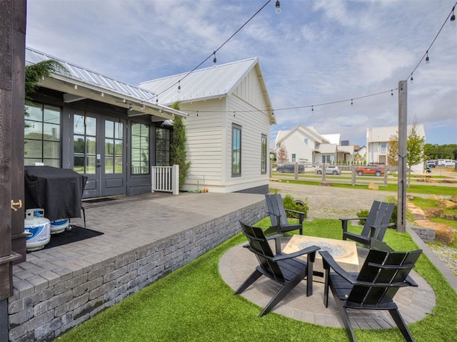 56 Center Ln, Carlton Landing, OK 2023 - view of patio with french doors, a grill, and an outdoor fire pit