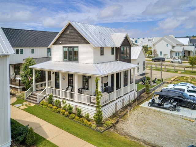 56 Center Ln, Carlton Landing, OK 2023 - view of front facade with a porch, a metal roof, and a residential view