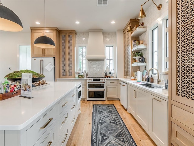 56 Center Ln, Carlton Landing, OK 2023 - kitchen featuring white appliances, custom range hood, open shelves, light wood-style floors, and light countertops