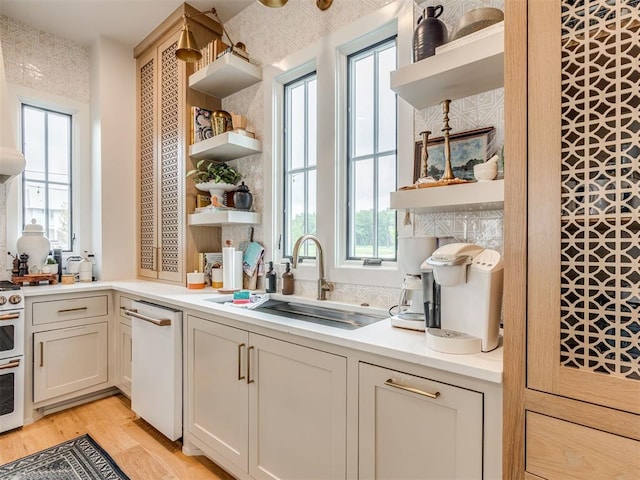 56 Center Ln, Carlton Landing, OK 2023 - kitchen with open shelves, white dishwasher, light wood-style flooring, and plenty of natural light