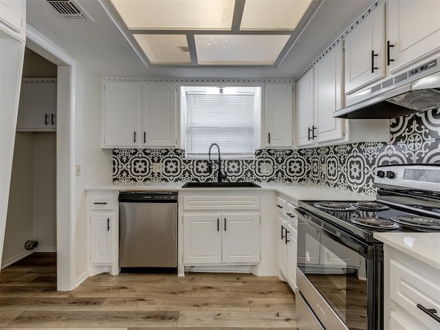 kitchen with sink, electric range oven, light wood-type flooring, stainless steel dishwasher, and white cabinets