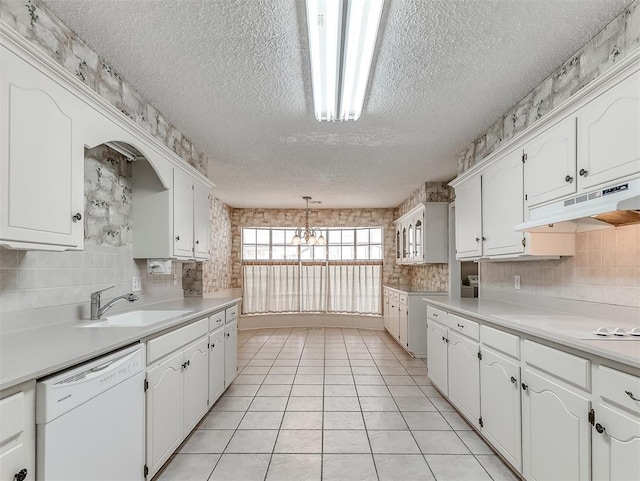 kitchen featuring decorative light fixtures, a textured ceiling, white dishwasher, decorative backsplash, and white cabinets