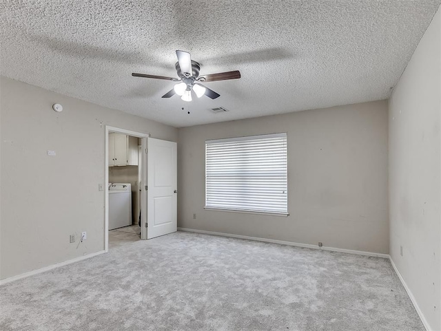 unfurnished bedroom with washer / dryer, light carpet, a textured ceiling, and ceiling fan