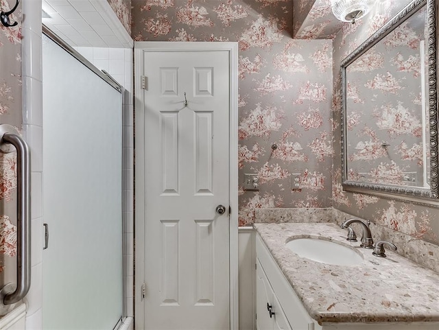 bathroom featuring vanity and a shower with shower door