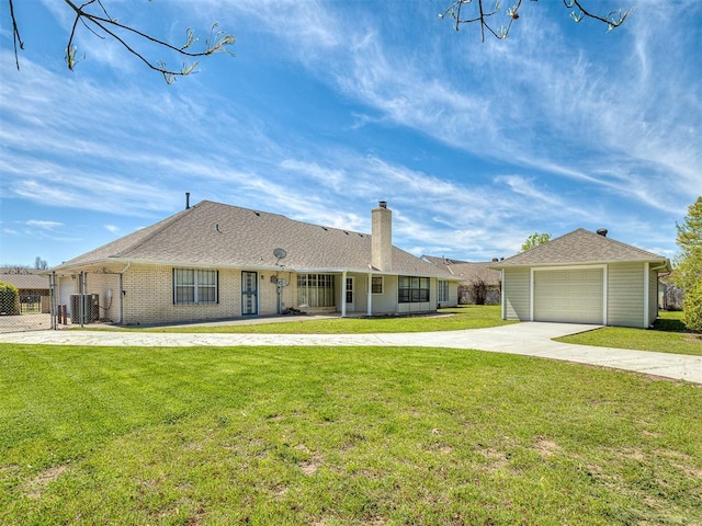 ranch-style home featuring a garage, a front yard, and central air condition unit