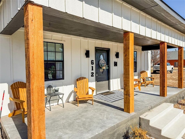 view of exterior entry featuring covered porch