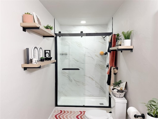 bathroom with toilet and an enclosed shower