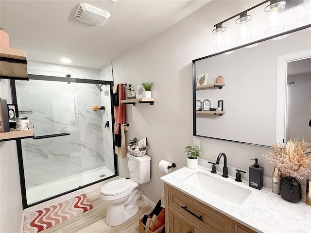 bathroom featuring vanity, toilet, hardwood / wood-style floors, and an enclosed shower