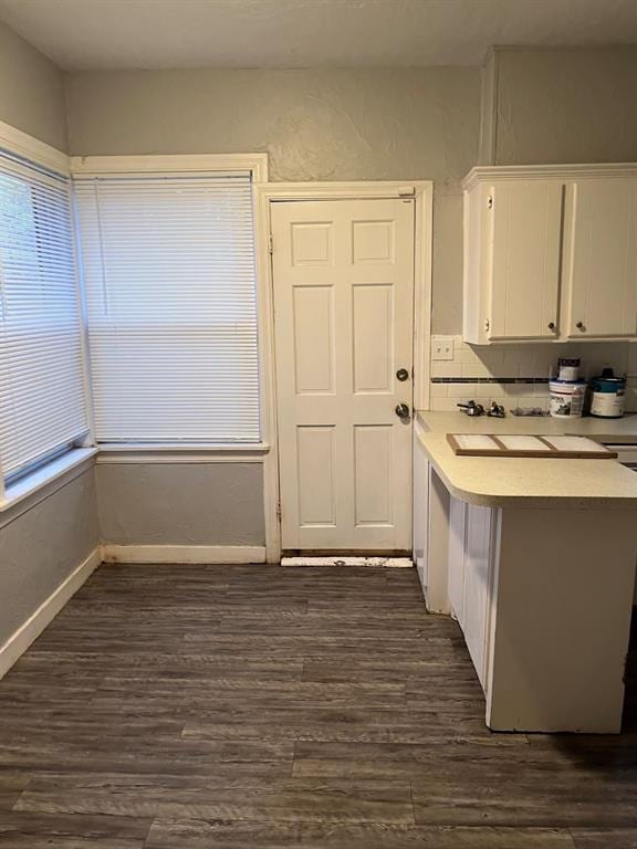 kitchen featuring tasteful backsplash, dark hardwood / wood-style flooring, and white cabinets