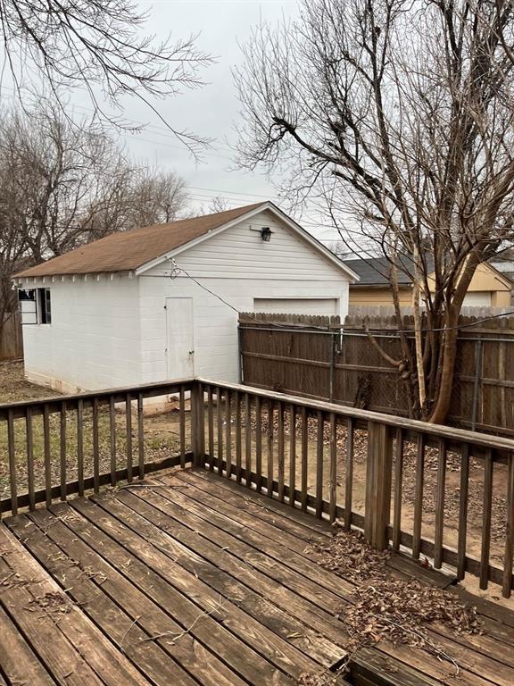 deck with an outbuilding and a garage