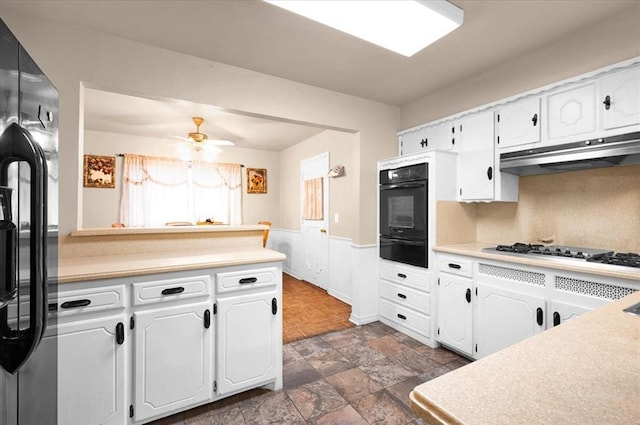 kitchen featuring black appliances, white cabinets, decorative backsplash, and ceiling fan