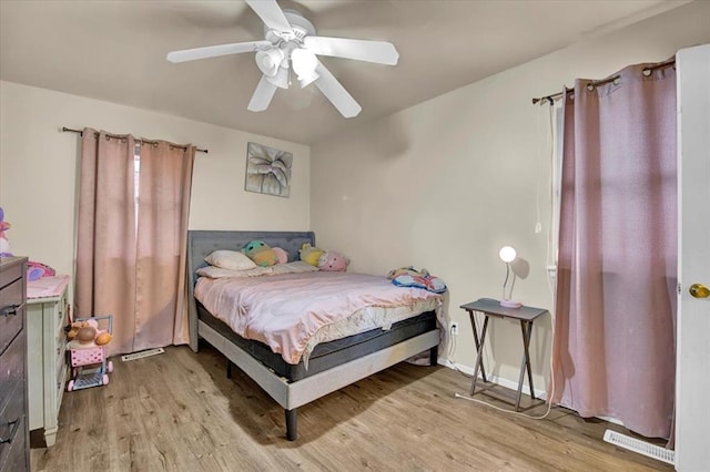 bedroom with ceiling fan and light hardwood / wood-style floors