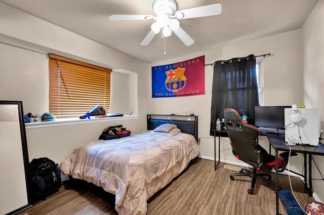 bedroom with ceiling fan and hardwood / wood-style flooring