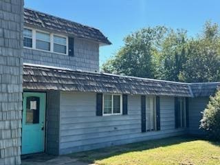 rear view of property featuring a yard