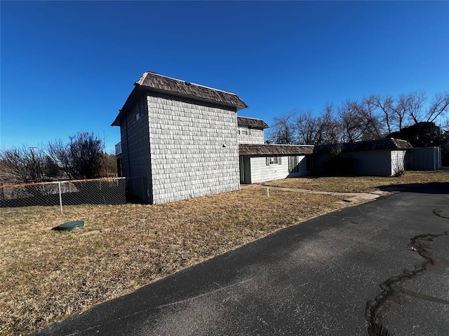 view of side of home featuring a lawn