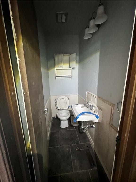 bathroom with sink, tile patterned floors, and toilet