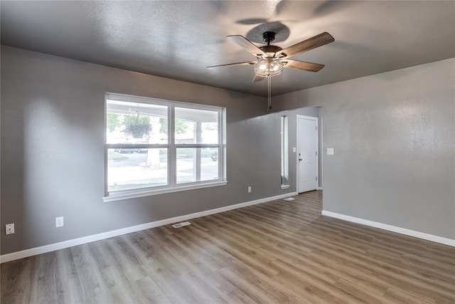 empty room featuring light hardwood / wood-style flooring and ceiling fan