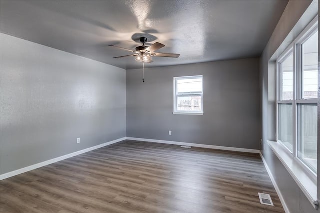 empty room featuring ceiling fan and dark hardwood / wood-style floors