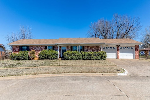 ranch-style home featuring an attached garage, brick siding, and driveway