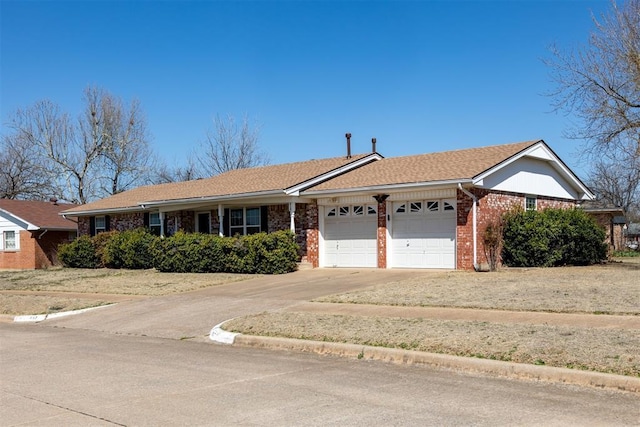 ranch-style house with an attached garage, brick siding, and driveway