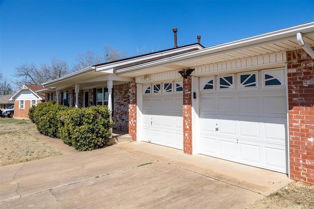 ranch-style house with concrete driveway, an attached garage, and brick siding