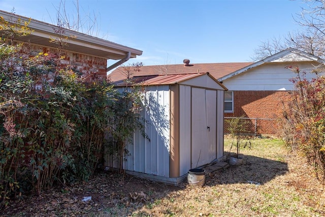 view of shed featuring fence