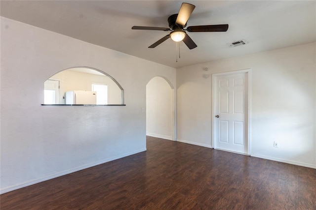 unfurnished room featuring dark hardwood / wood-style floors and ceiling fan