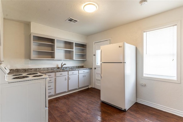 kitchen featuring sink, white appliances, dark hardwood / wood-style floors, and stone counters