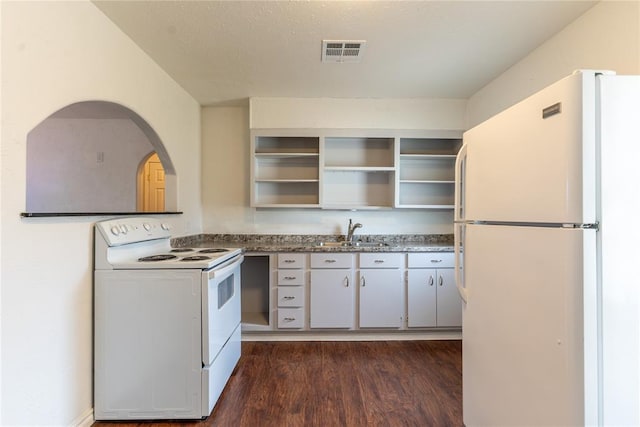 kitchen featuring sink, white appliances, and dark wood-type flooring