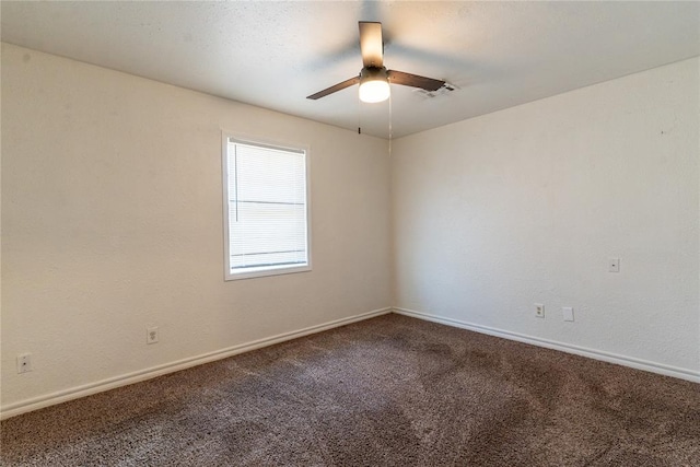 carpeted spare room featuring ceiling fan