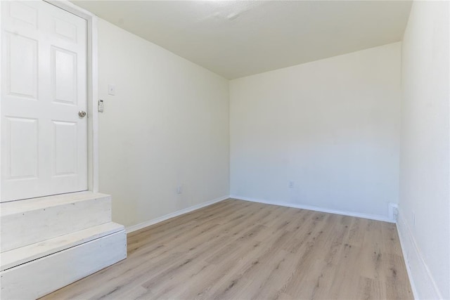 unfurnished room with light wood-type flooring