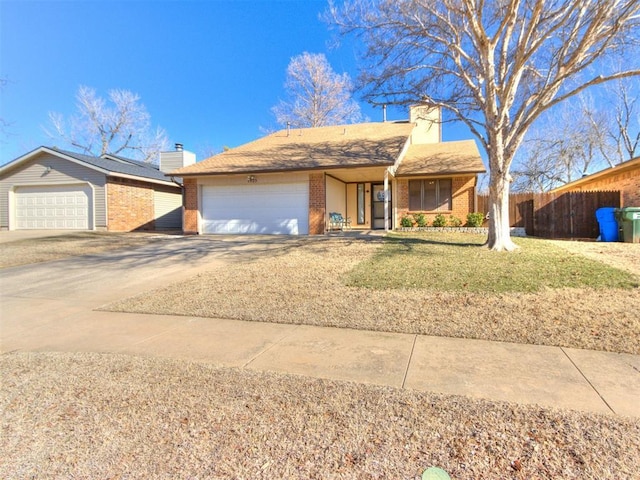 ranch-style house featuring a front yard and a garage