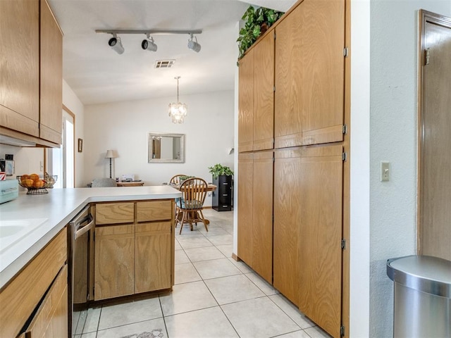 kitchen with pendant lighting, dishwasher, rail lighting, kitchen peninsula, and light tile patterned floors