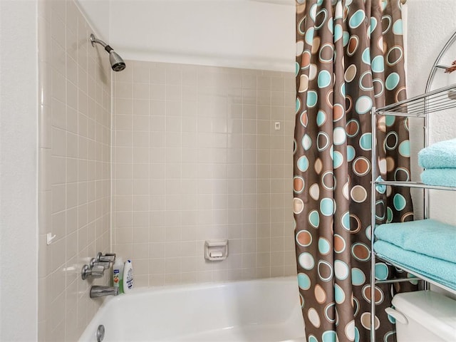 bathroom featuring toilet and shower / tub combo with curtain