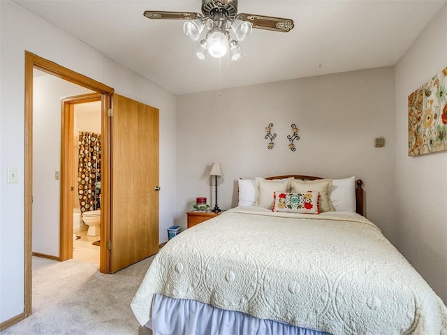 bedroom with light colored carpet, connected bathroom, and ceiling fan