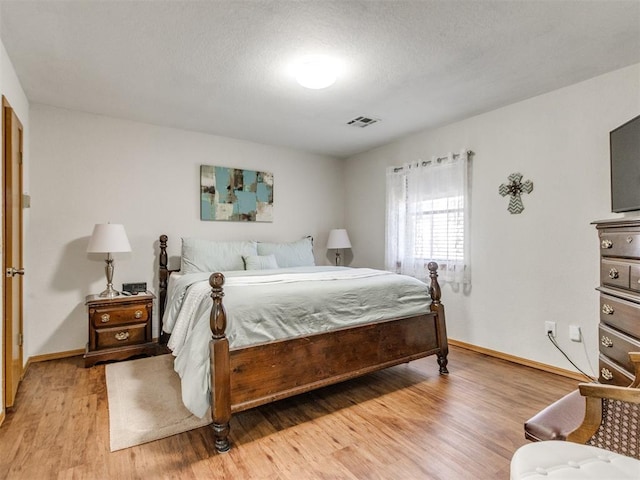 bedroom with light wood-type flooring