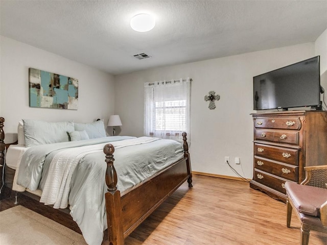 bedroom with light hardwood / wood-style floors