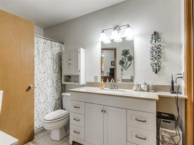 bathroom with toilet, tile patterned flooring, and vanity