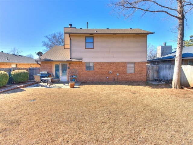 back of house featuring a patio area and a lawn