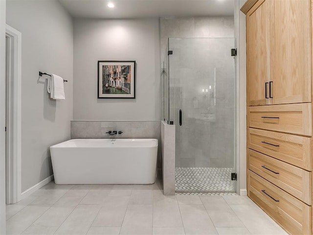 bathroom featuring tile patterned flooring and separate shower and tub